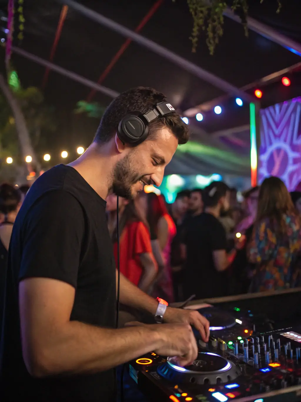 An energetic photo of a DJ performing live in front of a crowd, capturing the excitement and performance skills taught in the Live Performance course at BeatMaster Academy.